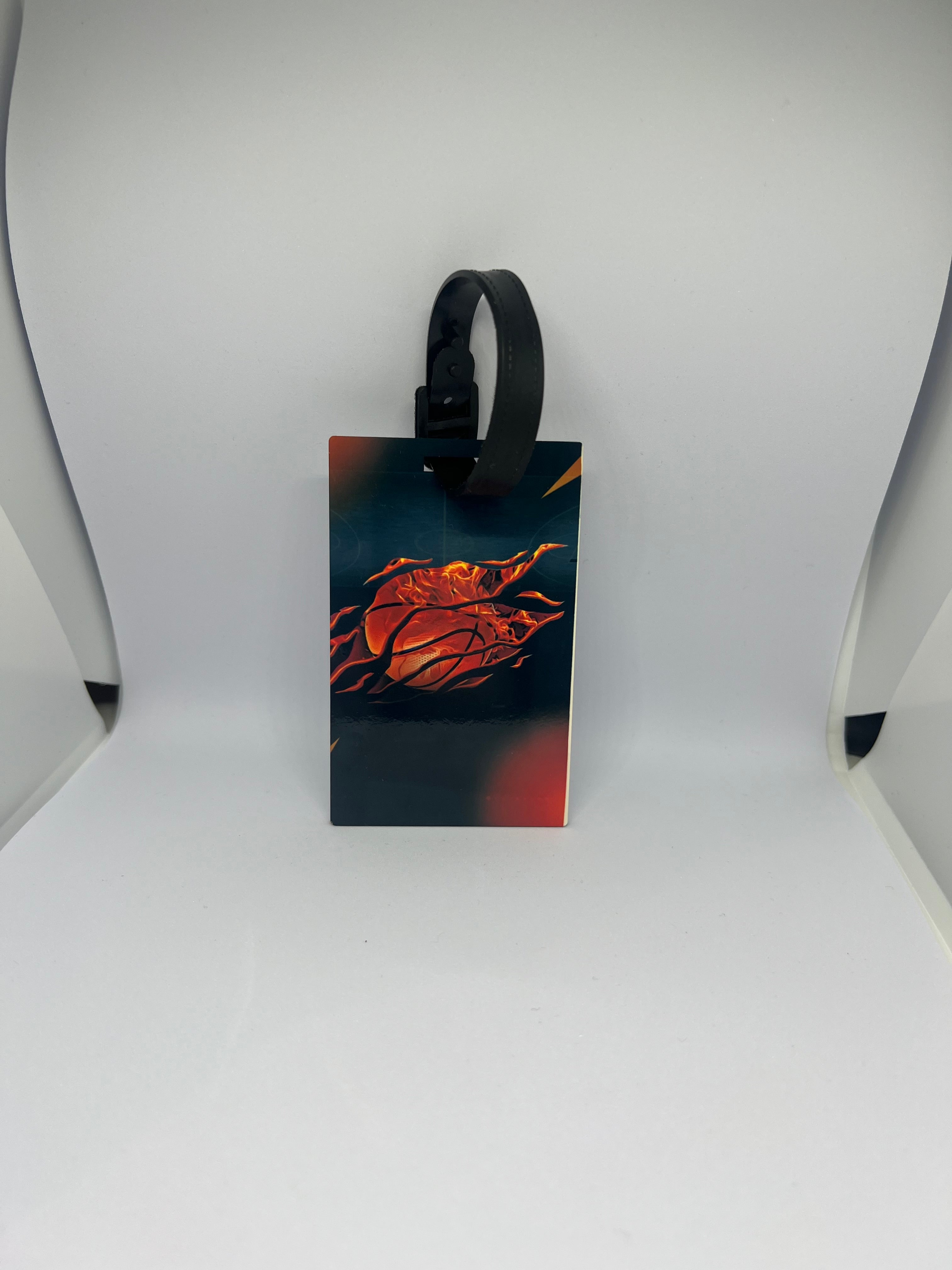 Flaming basketball luggage tag with dark teal and red fire design and black strap