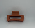 Terracotta burnt orange matte rectangle hair claw clip with open design and strong grip teeth