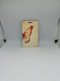 Watercolour butterfly luggage tag with star trail details on soft cream background