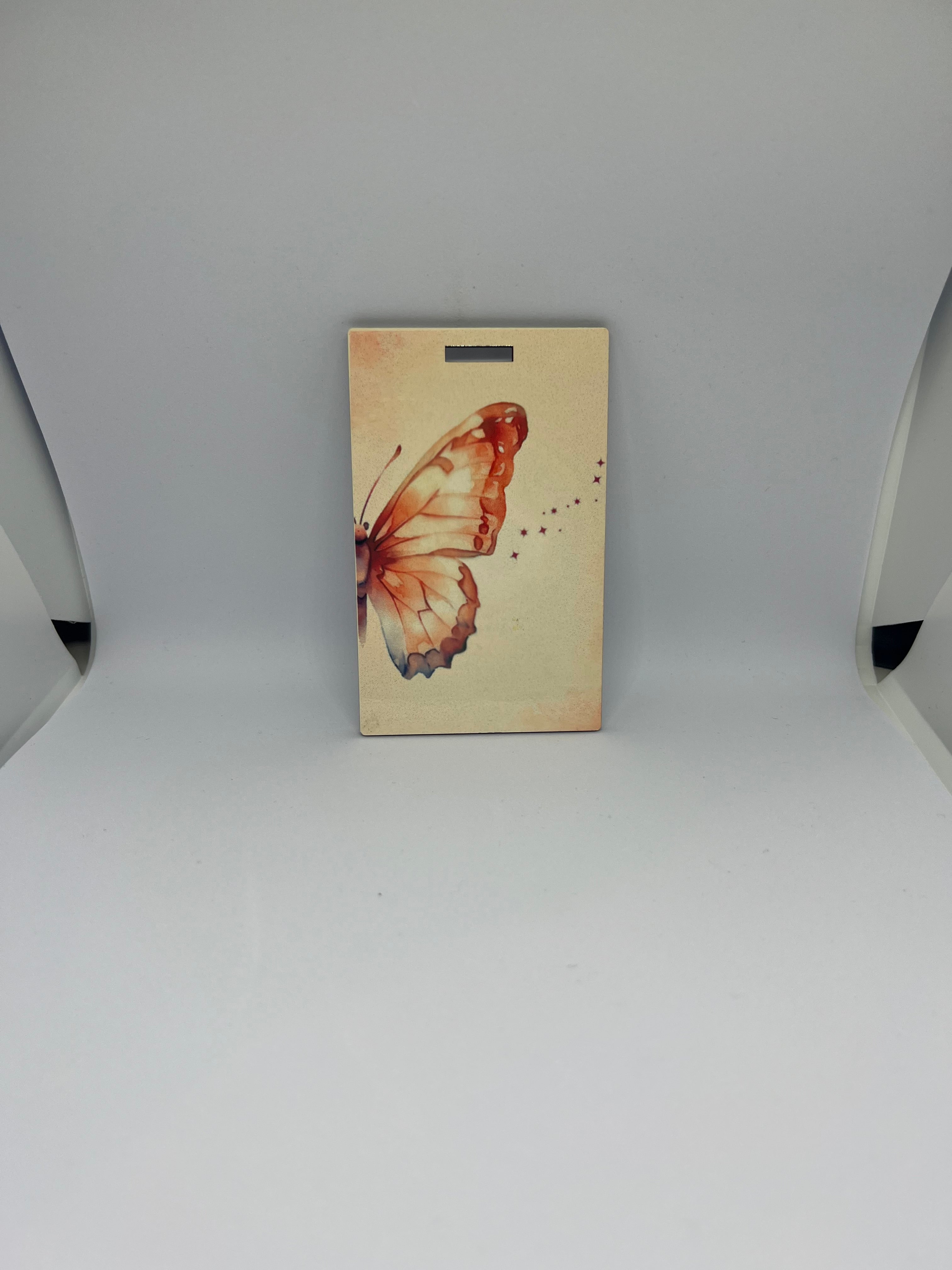 Watercolour butterfly luggage tag with star trail details on soft cream background