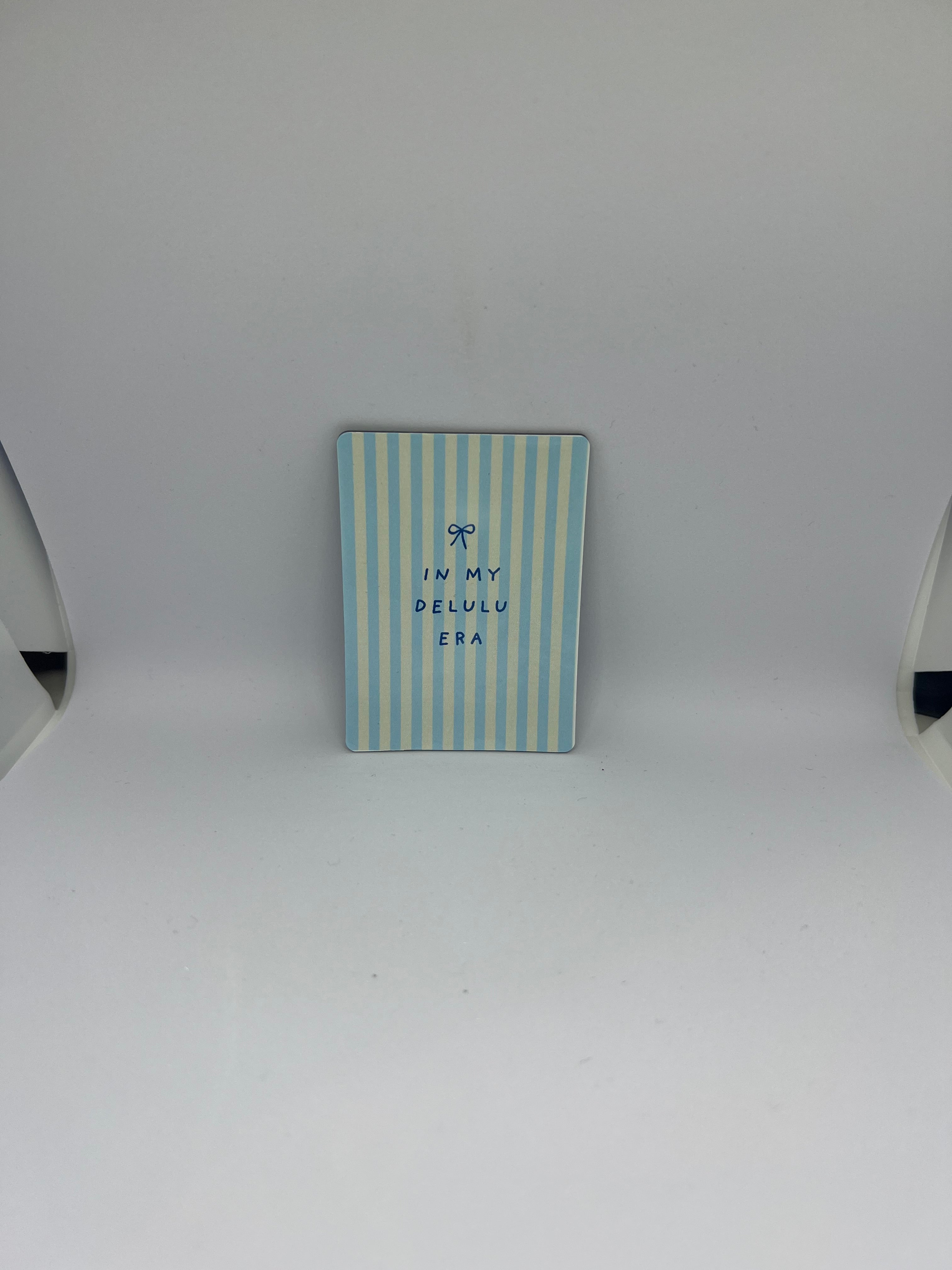 In My Delulu Era magnet with pastel blue yellow stripe design and bow