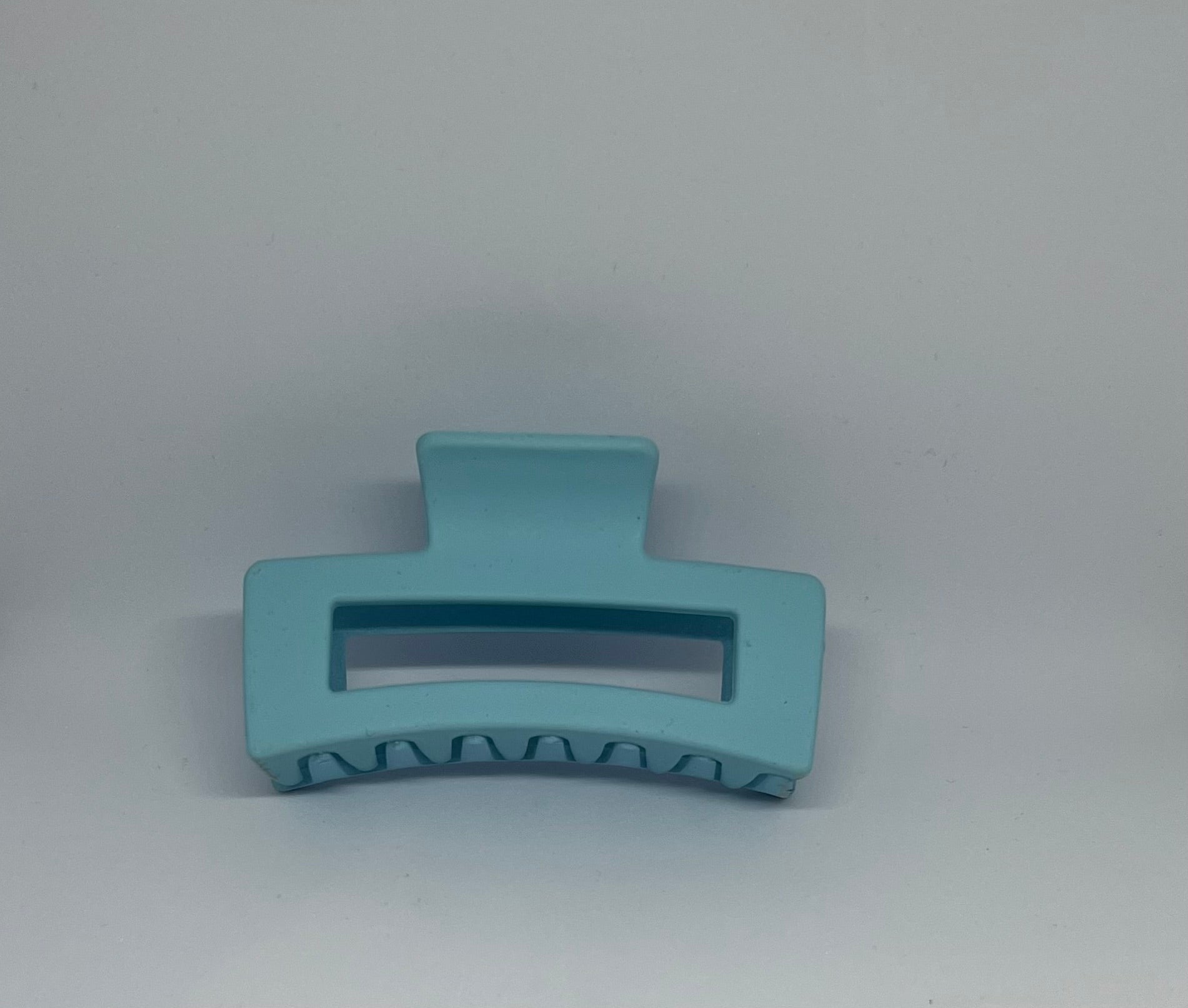 Sky blue matte rectangle hair claw clip with open design and strong grip teeth