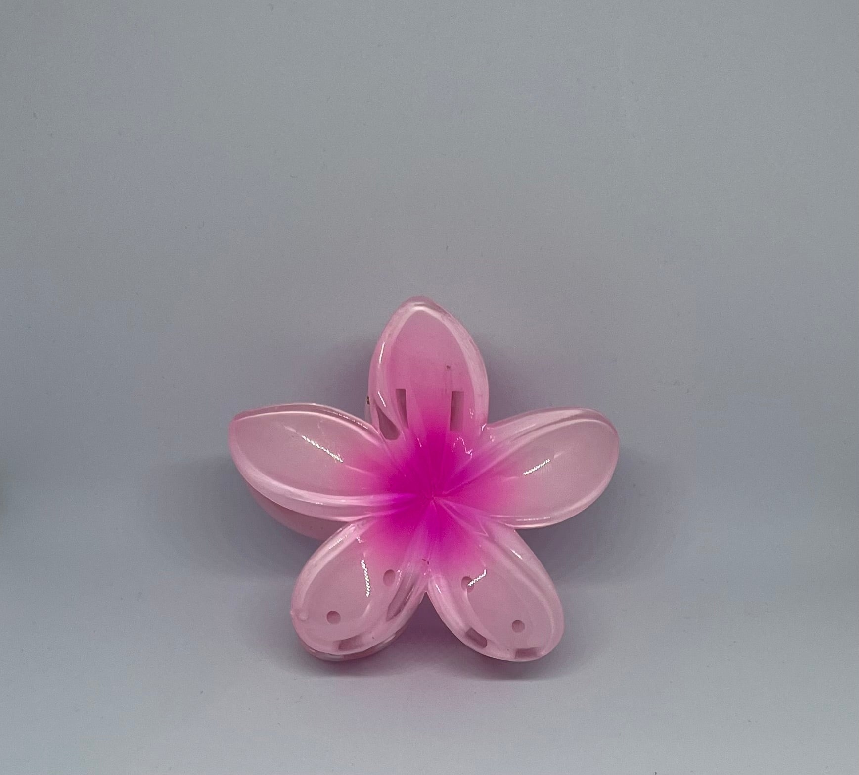 Pink frangipani flower hair claw clip with translucent blush pink petals and hot pink centre