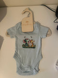 Light blue baby onesie with watercolour elephant giraffe and lamb print on wooden newborn hanger
