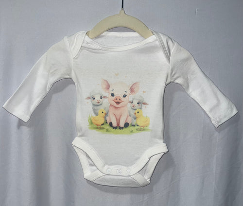 White long sleeve baby onesie with watercolour piglet lambs and chicks farm animals print on hanger