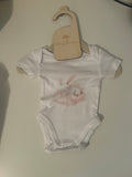 White short sleeve baby onesie with watercolour sleepy bunny in blush and white tones on newborn hanger