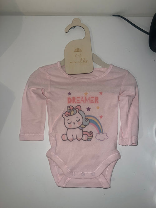 Blush pink long sleeve baby onesie with unicorn rainbow and Dreamer print on 0-3 months hanger
