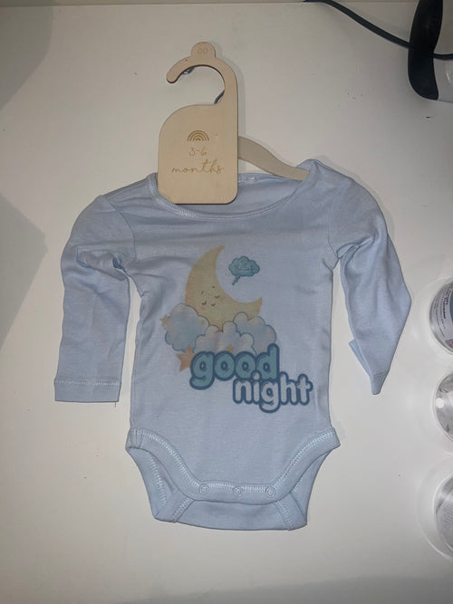 Sky blue long sleeve baby onesie with sleepy moon on clouds and Good Night print on 3-6 months hanger