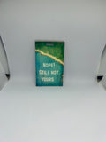 Nope Still Not Yours luggage tag with bold white text over aerial coastal forest and turquoise water