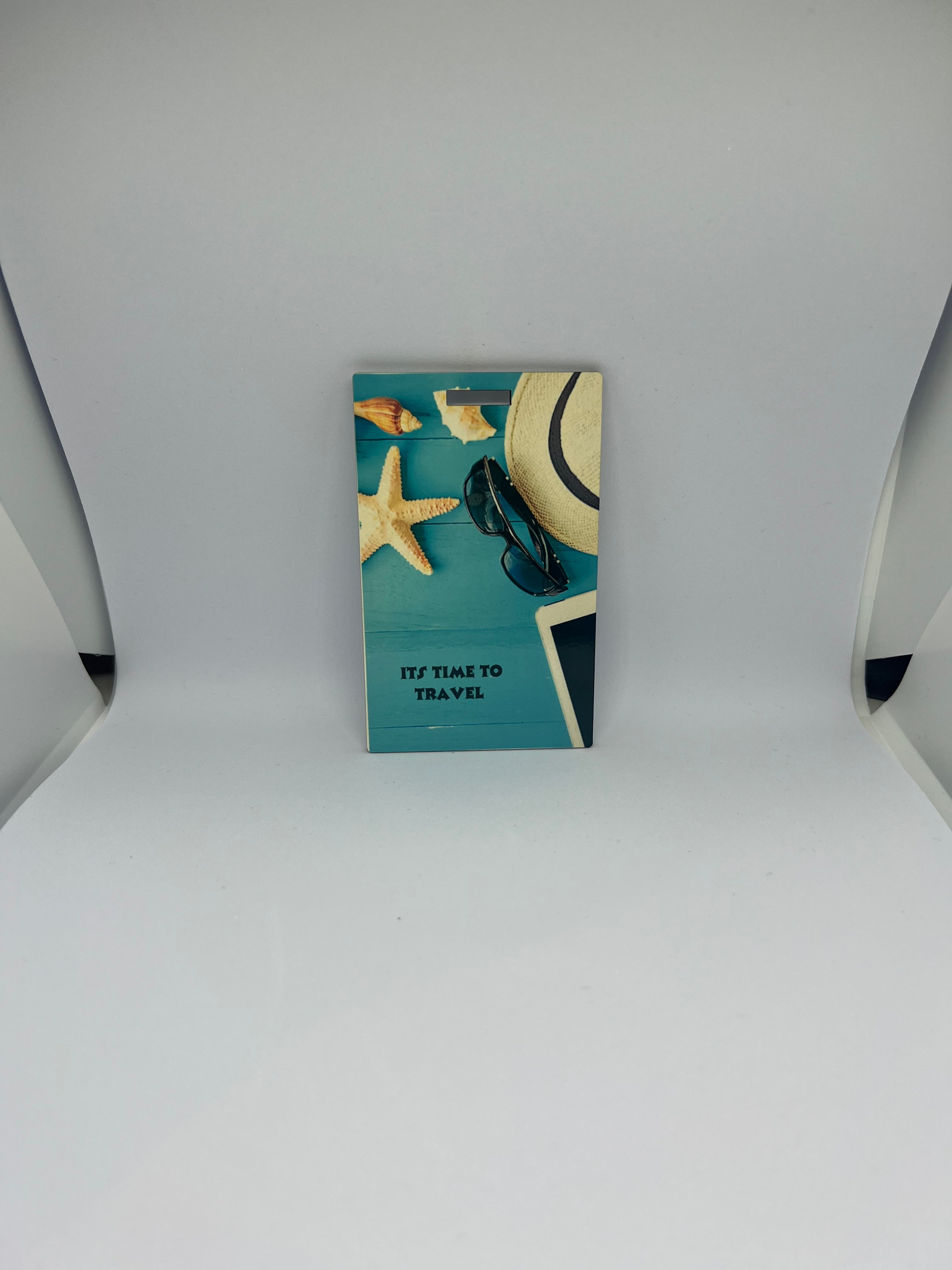 It's Time to Travel beach essentials luggage tag with straw hat sunglasses starfish and seashells on teal background
